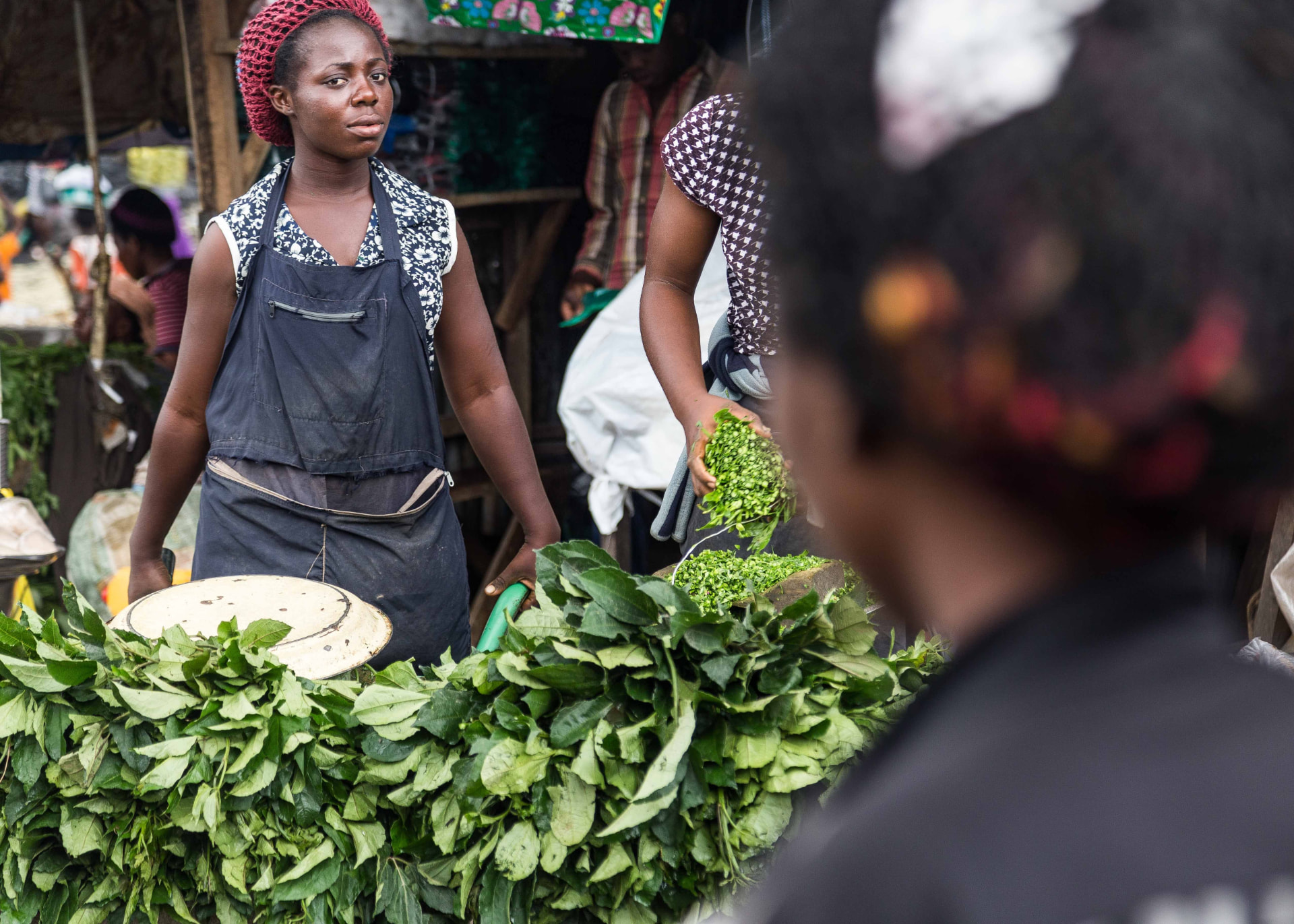 A vegetable seller at her market stall